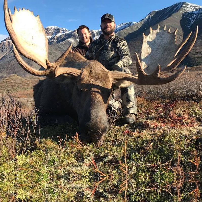 A hunter and hunting guide behind an Elk kill.